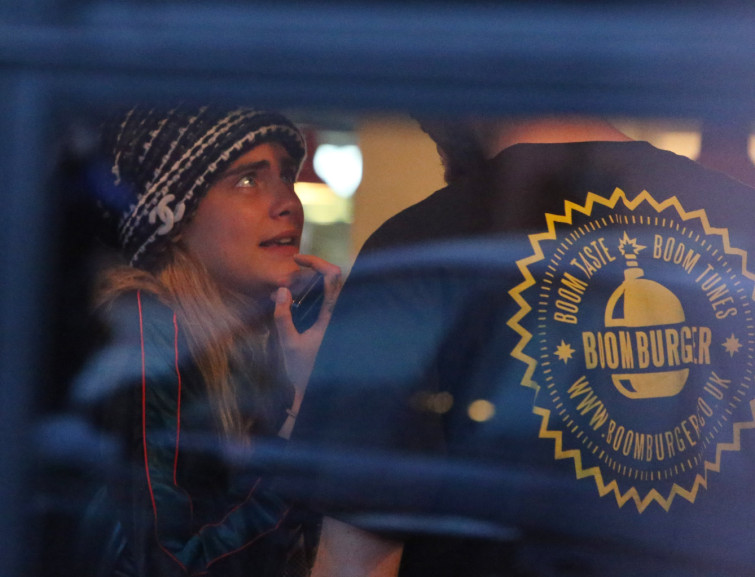 Cara Delevingne goes to a burger bar with a male companion and other friends